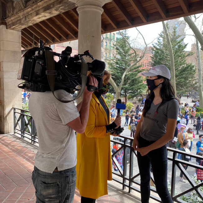 A NAPAWF member is interviewed by a TV crew.